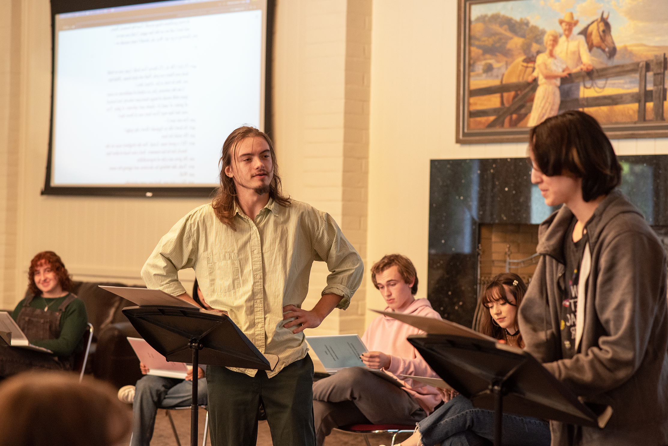 Students performing a play-reading of Angels America in Claeys Lounge