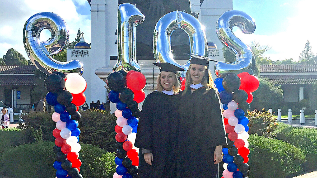 Lauren Breen and Nicole Haskins in front of the Saint Mary's chapel, 2019 graduation ceremony.