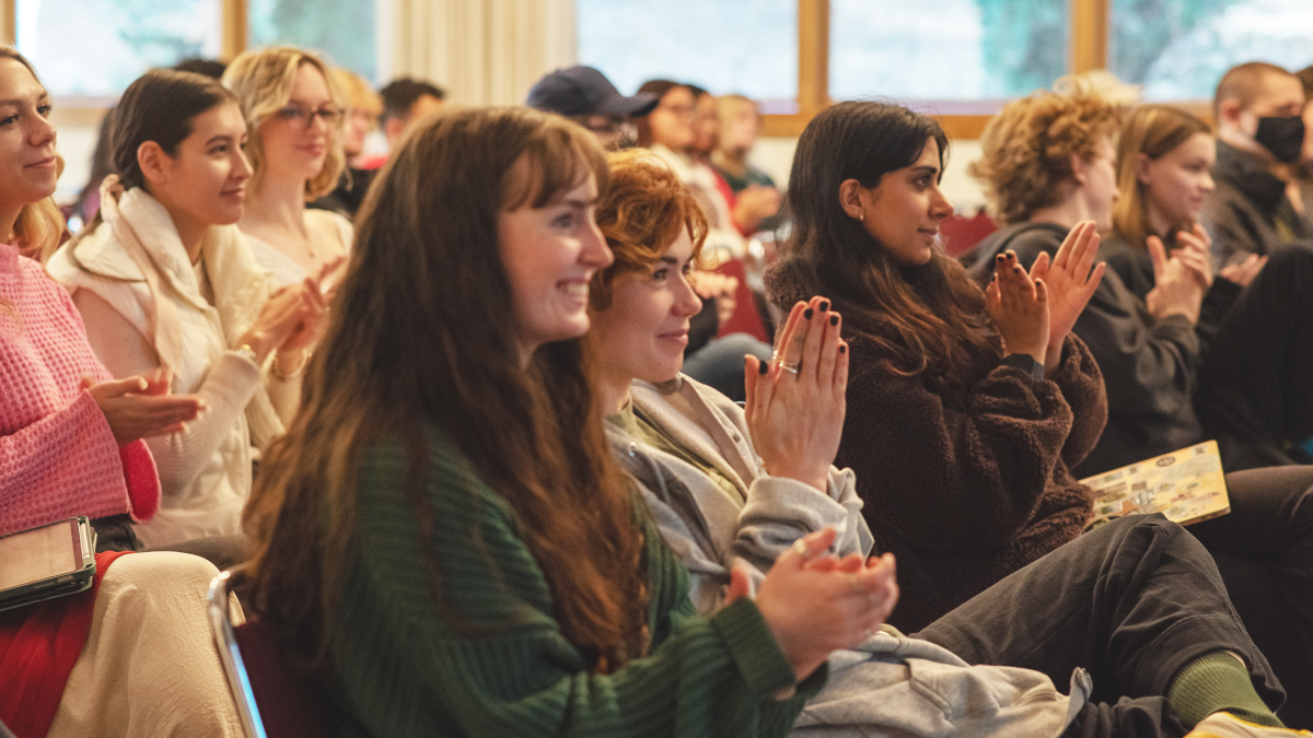 Students in Clayes clapping at a staged reading of Angels in America